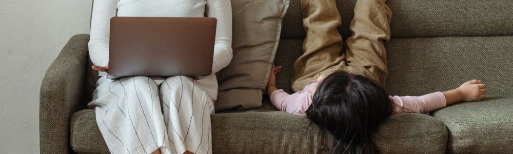 Woman sits on couch to work from home